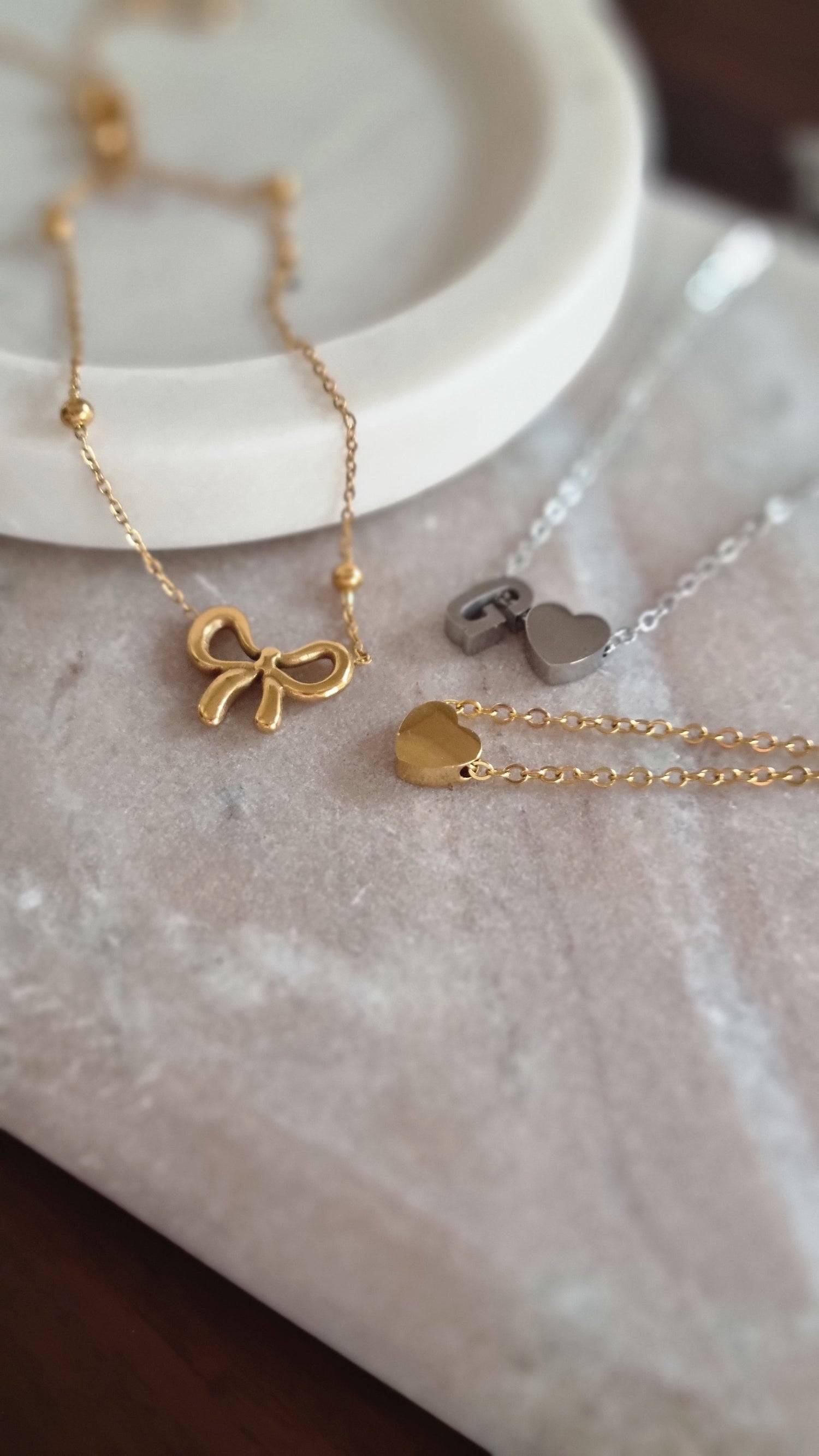 Model wearing a gold Dolly & Naana Love Letter initial necklace - the perfect personalised gift