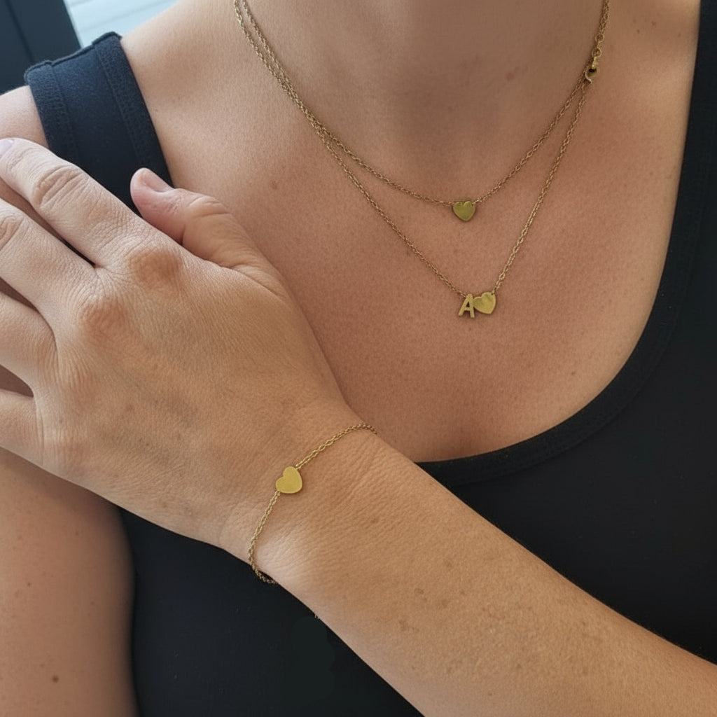 Woman wearing gold heart necklace and bracelete